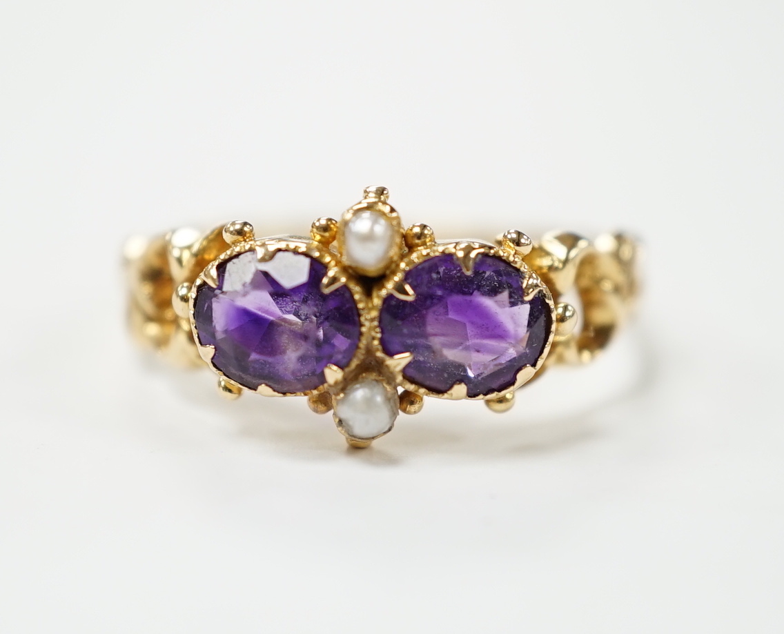 A Victorian style yellow metal, amethyst and pearl dress ring, size L
